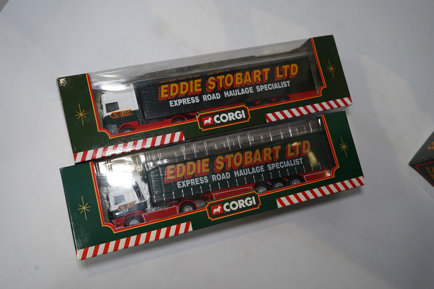 Fourteen boxed Corgi diecast Eddie Stobart commercial vehicles, including articulated tractor and trailer units, a Douglas DC-3 aircraft, flatbed lorries, etc. Condition - good.